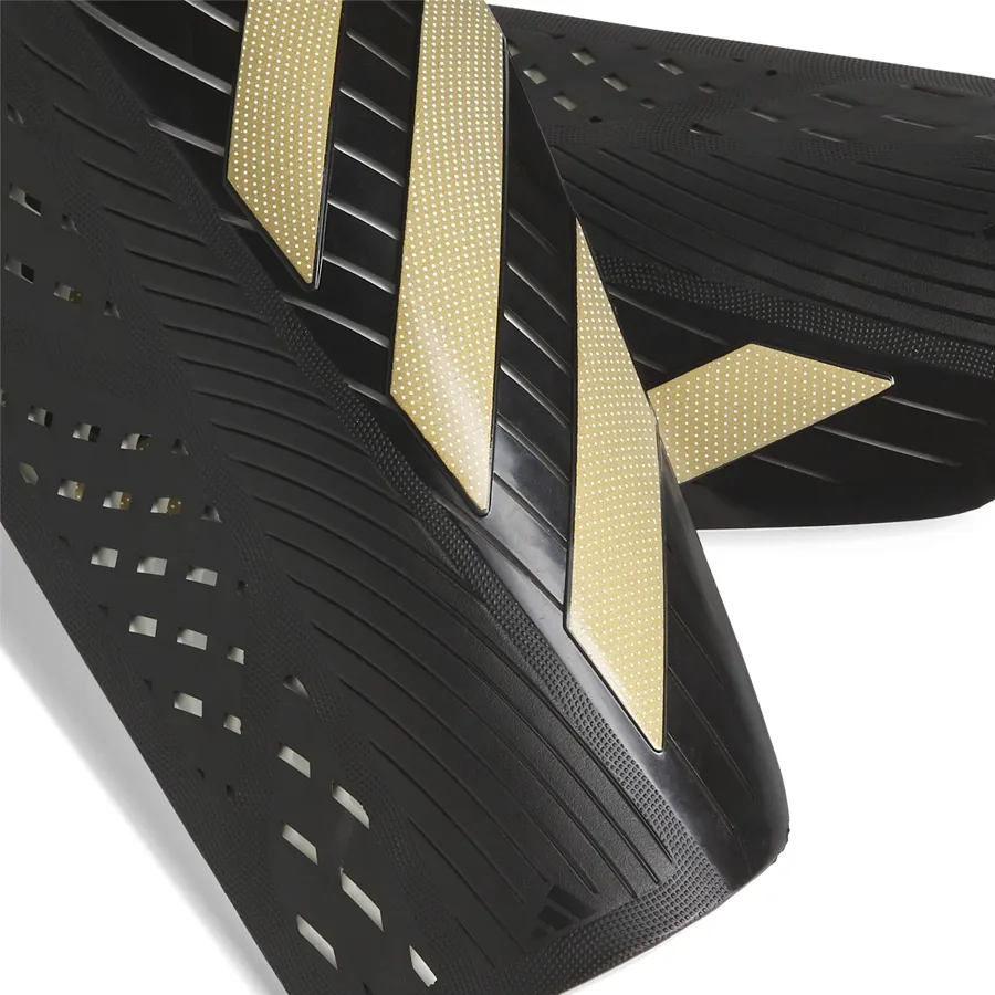 Imagen 1 de 3 de Canilleras adidas Tiro Sg Clb-NEGRO/DORADO